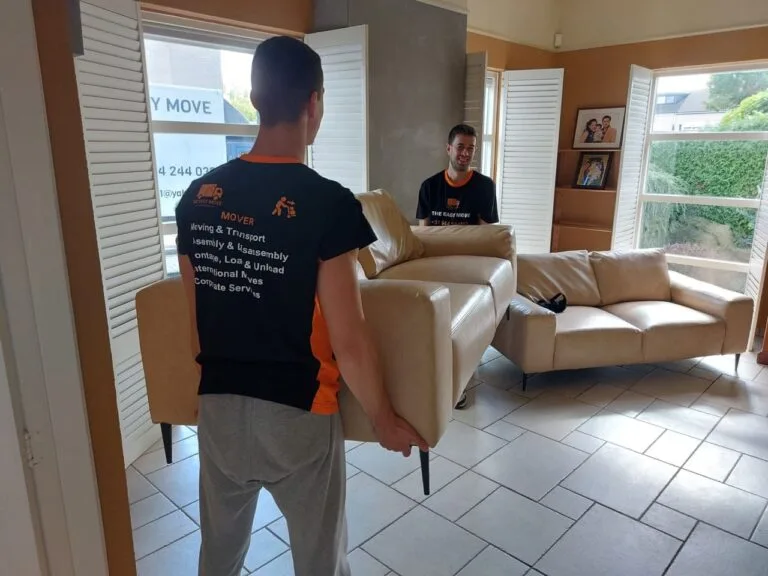 Movers in Hasselt carrying sofa with care